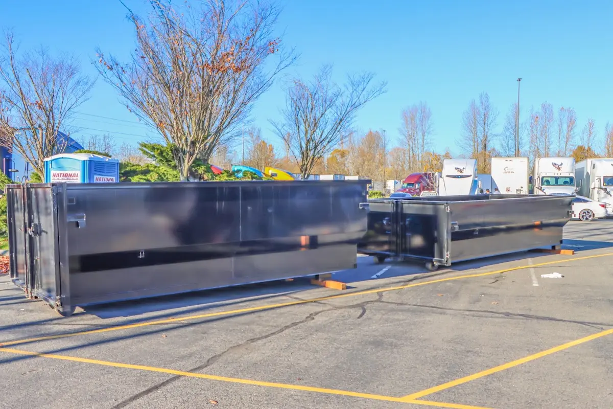 Professional dumpster rental service with roll-off container on residential driveway in Dunn